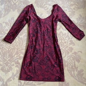 Red party dress. Black floral design.